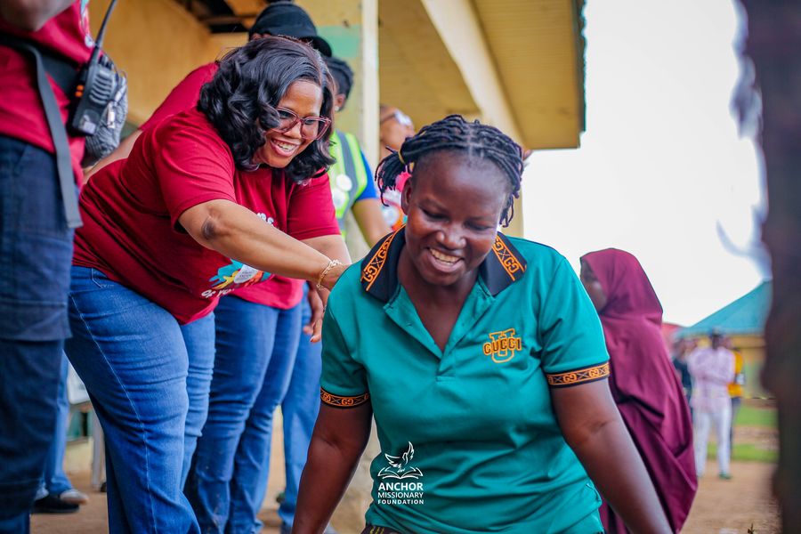 Two team members sharing a joyful moment at an outreach event
